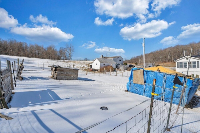 snowy yard with fence