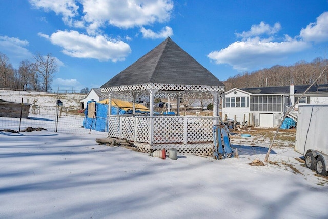 yard covered in snow with a gazebo