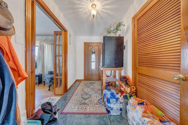 interior space with baseboards and wood finished floors