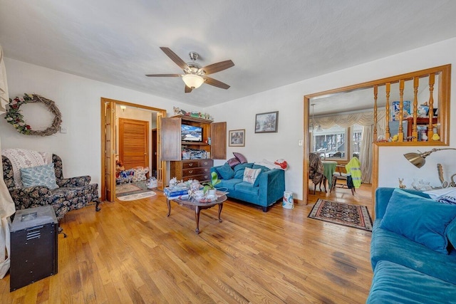 living area featuring a ceiling fan and wood finished floors