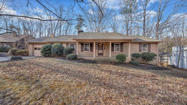 single story home featuring a garage and covered porch