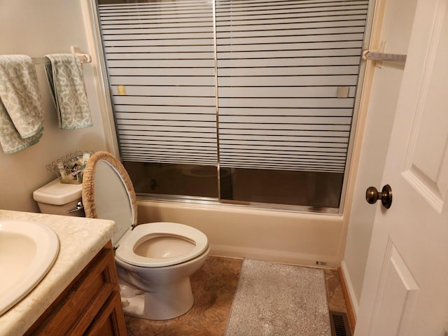 full bathroom with toilet, vanity, and bath / shower combo with glass door