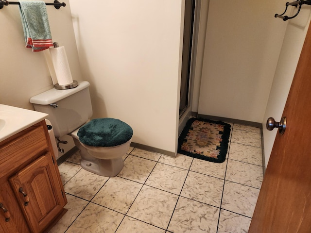 bathroom featuring vanity, tile patterned floors, and toilet