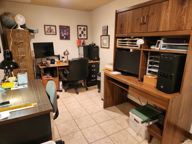 tiled office featuring a paneled ceiling