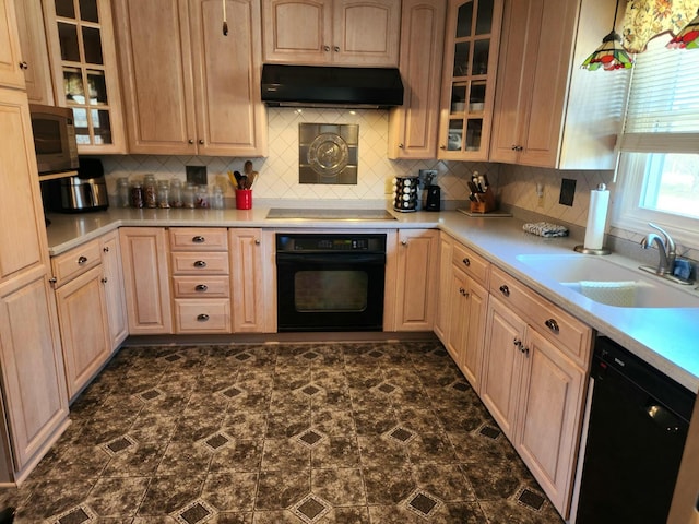 kitchen featuring range hood, sink, light brown cabinetry, and black appliances