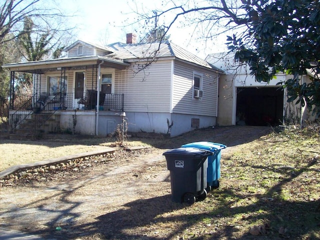 bungalow with cooling unit and covered porch