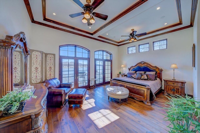 bedroom featuring french doors, ornamental molding, wood-type flooring, and ceiling fan