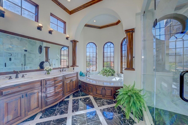 bathroom with vanity, ornamental molding, decorative columns, and plus walk in shower