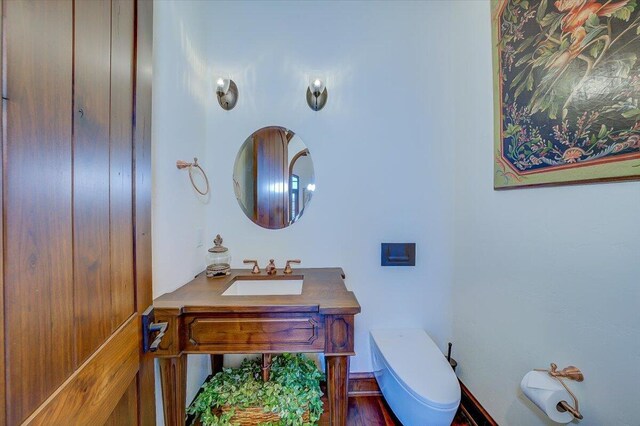 bathroom featuring vanity and toilet