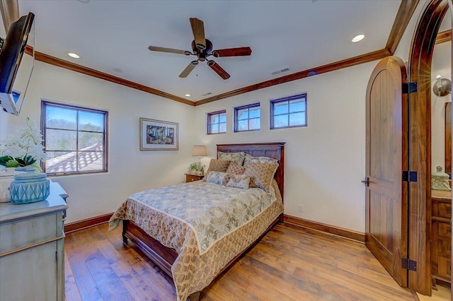 bedroom featuring hardwood / wood-style flooring, ceiling fan, and crown molding