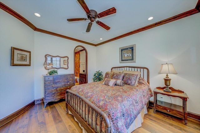 bedroom with hardwood / wood-style floors, crown molding, and ceiling fan