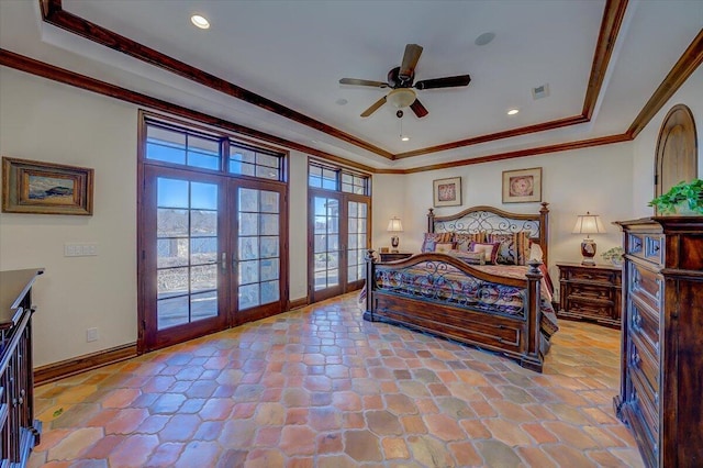 bedroom with a raised ceiling, ornamental molding, and french doors