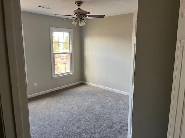 carpeted empty room with ceiling fan