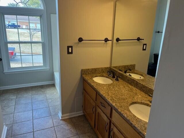 bathroom featuring vanity, plenty of natural light, and tile patterned floors