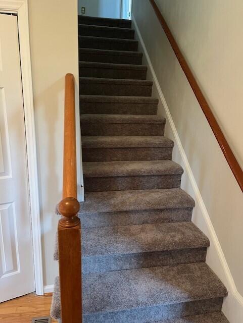 stairway featuring hardwood / wood-style floors