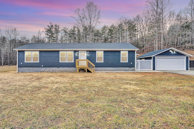 ranch-style house with crawl space, a detached garage, an outdoor structure, and a front yard