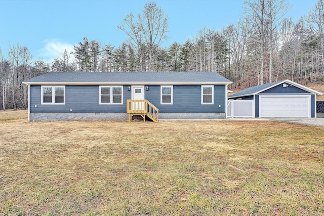 view of front facade with crawl space, a garage, an outdoor structure, and a front yard