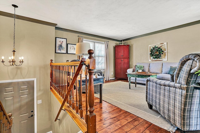 living room featuring ornamental molding, hardwood / wood-style floors, and a notable chandelier