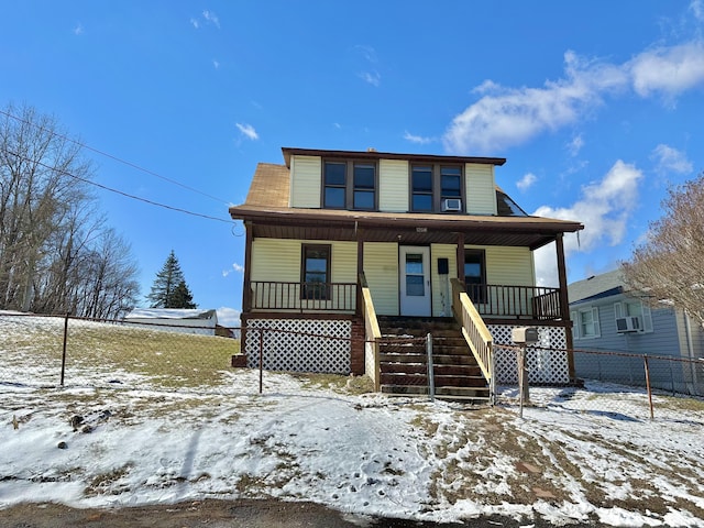 view of front of property with stairs, a porch, and cooling unit