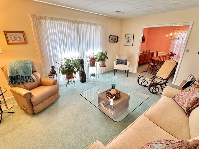 living room featuring a notable chandelier and carpet