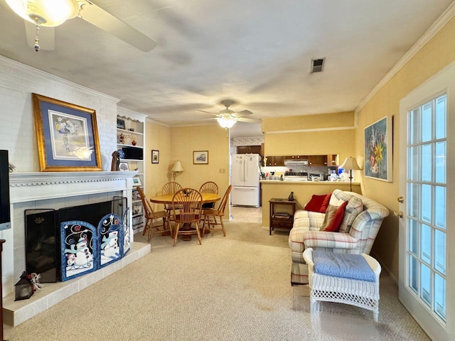 living room with ornamental molding, carpet floors, and ceiling fan