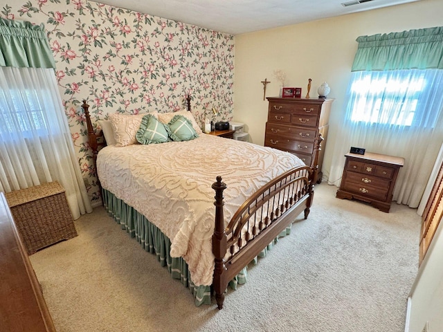 bedroom featuring light colored carpet