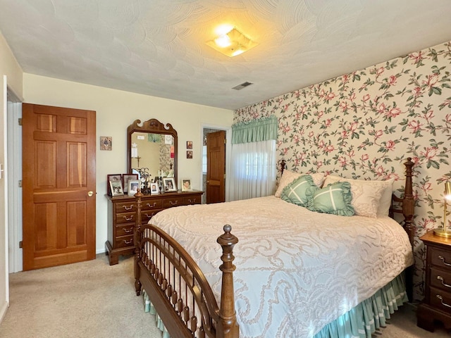 carpeted bedroom featuring a textured ceiling