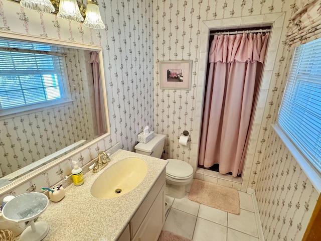 bathroom with tile patterned flooring, vanity, and toilet