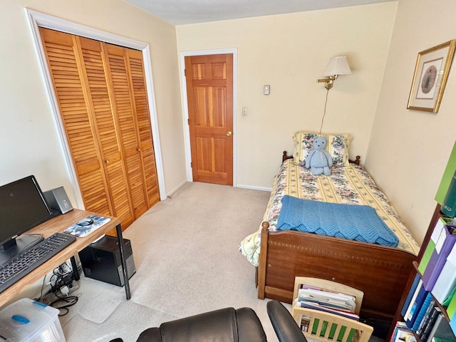 bedroom with a closet and light carpet