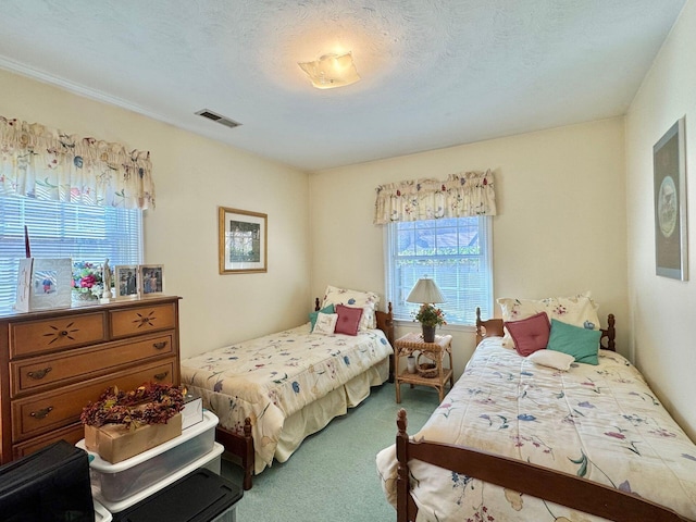 bedroom with carpet floors and a textured ceiling