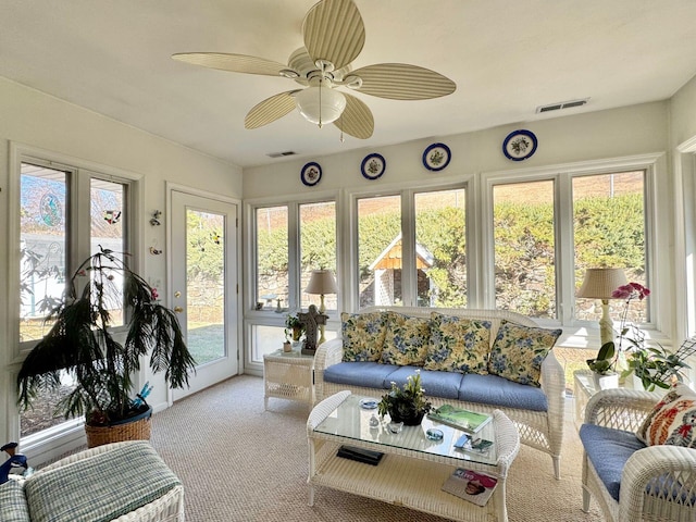 sunroom / solarium featuring ceiling fan