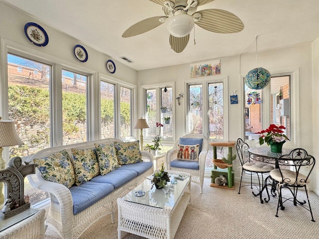 sunroom / solarium with ceiling fan and plenty of natural light