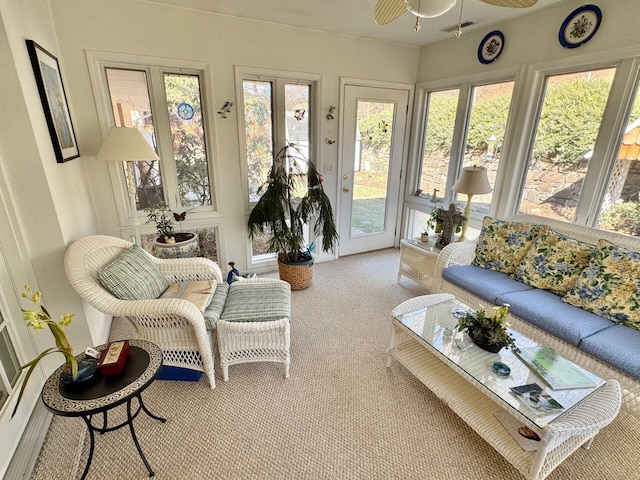 sunroom / solarium featuring ceiling fan