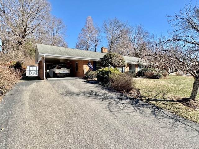 view of property exterior featuring a carport and a lawn