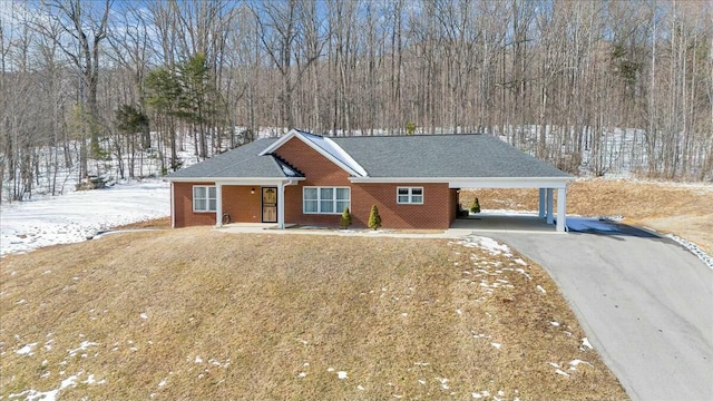 ranch-style house with a carport and a yard