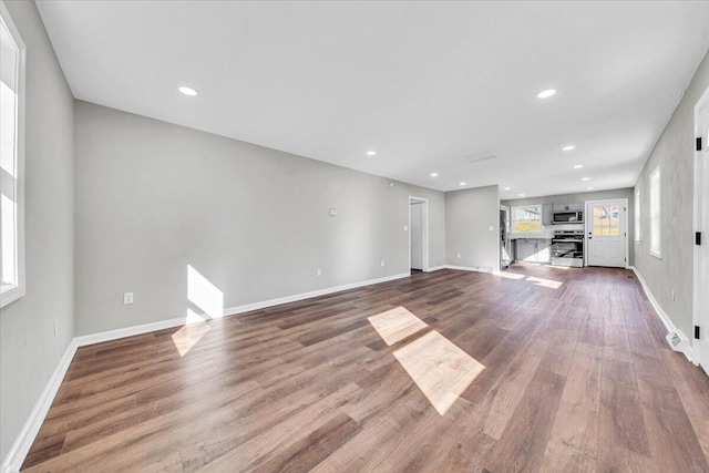 unfurnished living room with hardwood / wood-style flooring