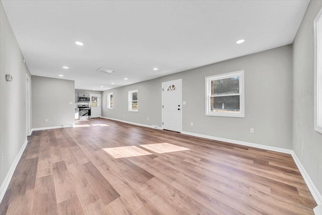 unfurnished living room with light hardwood / wood-style flooring