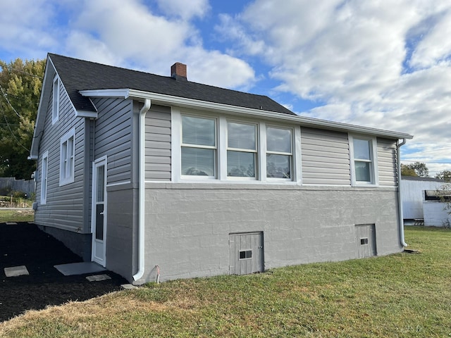 view of property exterior with a yard