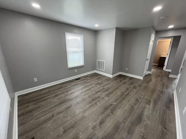 spare room featuring dark hardwood / wood-style floors