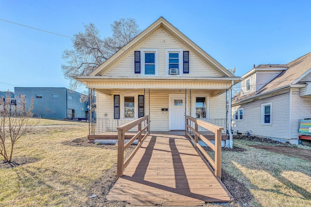 bungalow-style home featuring a porch and a front lawn