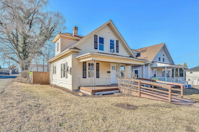 view of front of house with a porch and a front lawn