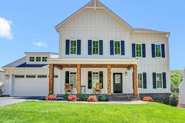modern inspired farmhouse featuring covered porch, board and batten siding, and driveway