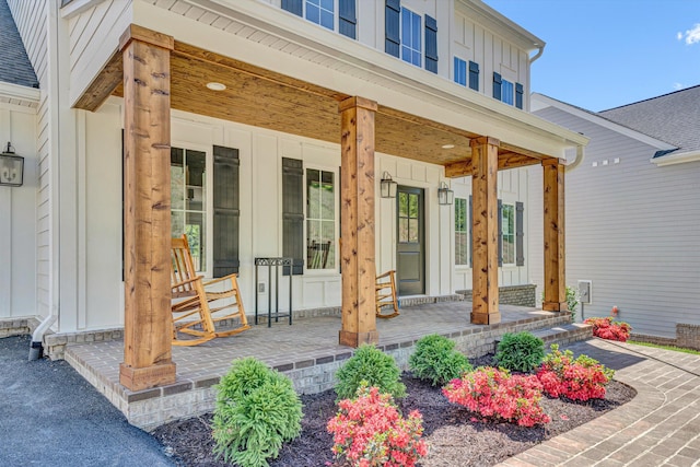 entrance to property featuring a porch and board and batten siding