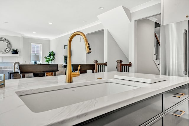 interior details with recessed lighting, a sink, freestanding refrigerator, and ornamental molding