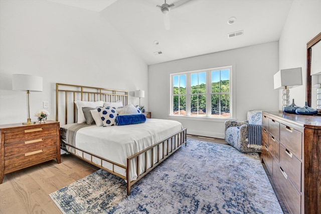 bedroom featuring ceiling fan, vaulted ceiling, light wood-type flooring, and visible vents