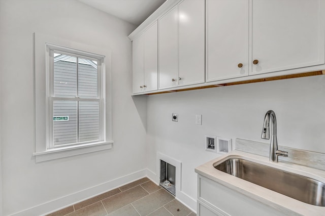 laundry room with cabinet space, washer hookup, a sink, electric dryer hookup, and baseboards