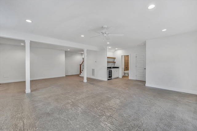 basement featuring ceiling fan, recessed lighting, and beverage cooler