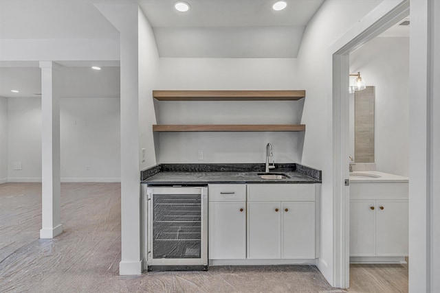 bar featuring recessed lighting, wet bar, a sink, and wine cooler