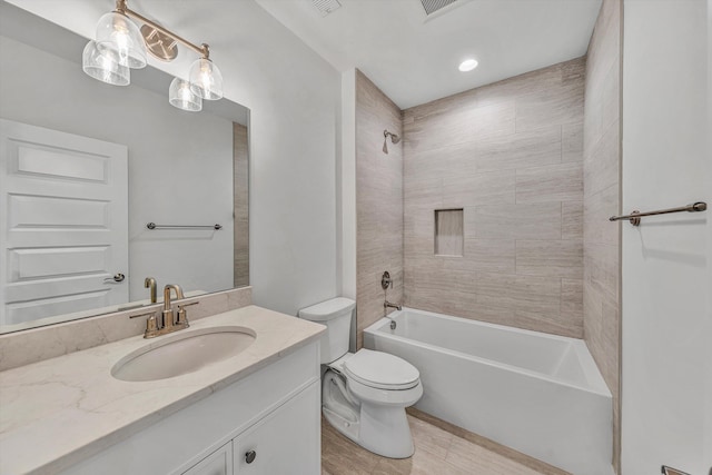 bathroom featuring vanity, tub / shower combination, and toilet