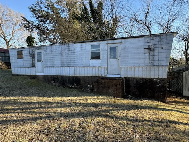 back of property featuring a lawn